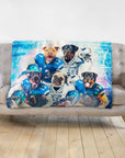 Personalized 5-pet blanket with dogs in blue football uniforms, displayed on a gray sofa.