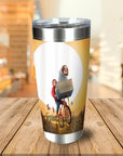 Personalized stainless steel tumbler with a custom dog and human riding a bicycle against a sunset.