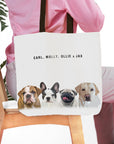 Personalized white canvas tote bag with custom watercolor portraits of four dogs and their names.