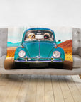 Personalized pet blanket with two dogs in a teal vintage Beetle car on a desert road.