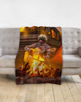 Personalized pet blanket with a pug playing guitar by a campfire, draped over a gray sofa.