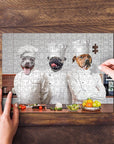 Personalized 3-pet puzzle featuring dogs as chefs, with a hand placing the last piece.