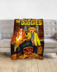 Personalized 'The Doggies' pet blanket with two dogs in adventure movie poster style, draped over a gray couch.