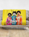 Yellow personalized pet blanket with three dogs in "The Doggo Beatles" renaissance-style costumes on a gray couch.