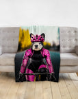Personalized pet blanket with a French Bulldog in a pink cycling outfit on a gray sofa.