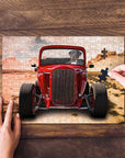 Personalized pet puzzle featuring a dog driving a red hot rod, with a hand placing a piece.