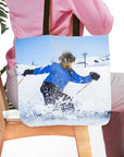 Personalized tote bag with a custom pet portrait of a dog skiing in a blue jacket.