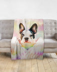 Personalized pet blanket with a French Bulldog unicorn portrait on a pastel background, draped over a gray sofa.