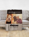 Personalized "The Woofing" blanket with custom pet portraits of a bulldog and a cat, draped on a gray sofa.