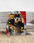 Personalized pet blanket featuring a bulldog in a hockey player portrait on a gray sofa.