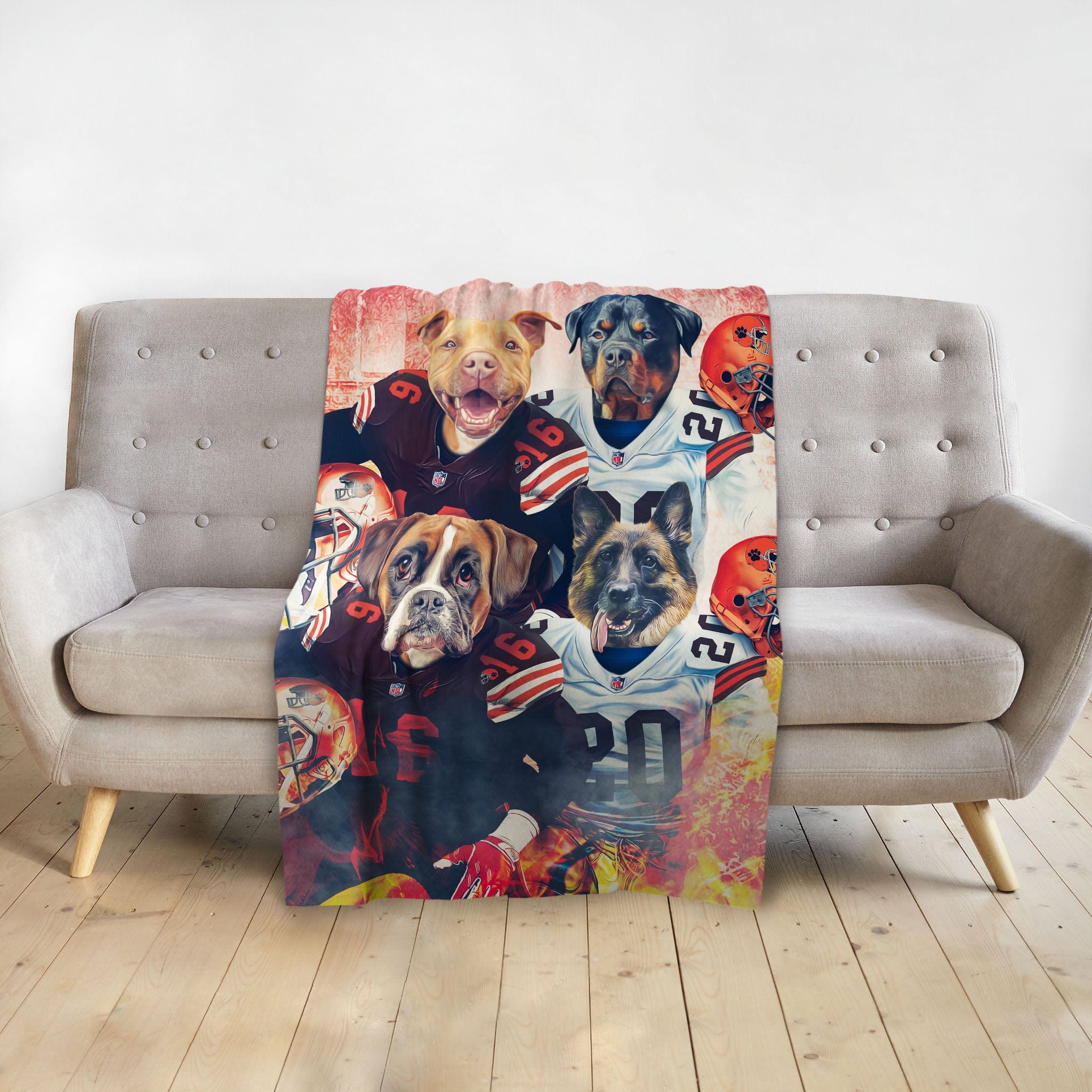 Personalized Doggovinci 4-pet blanket with dogs in football jerseys, on a grey couch.