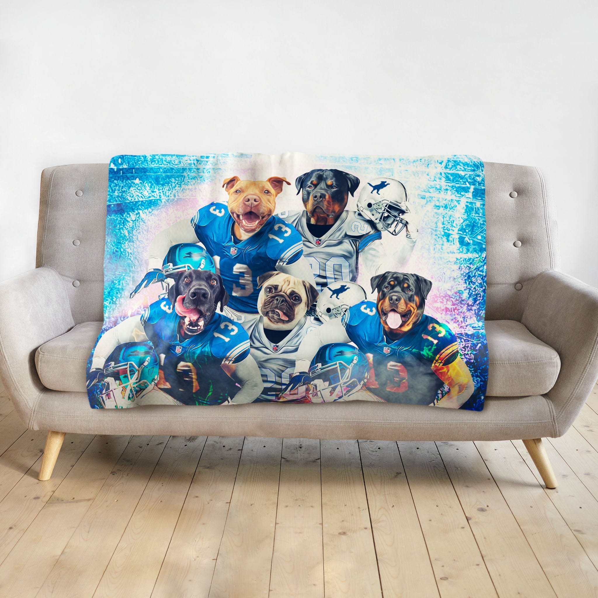 Personalized 5-pet blanket with dogs in blue football uniforms, displayed on a gray sofa.