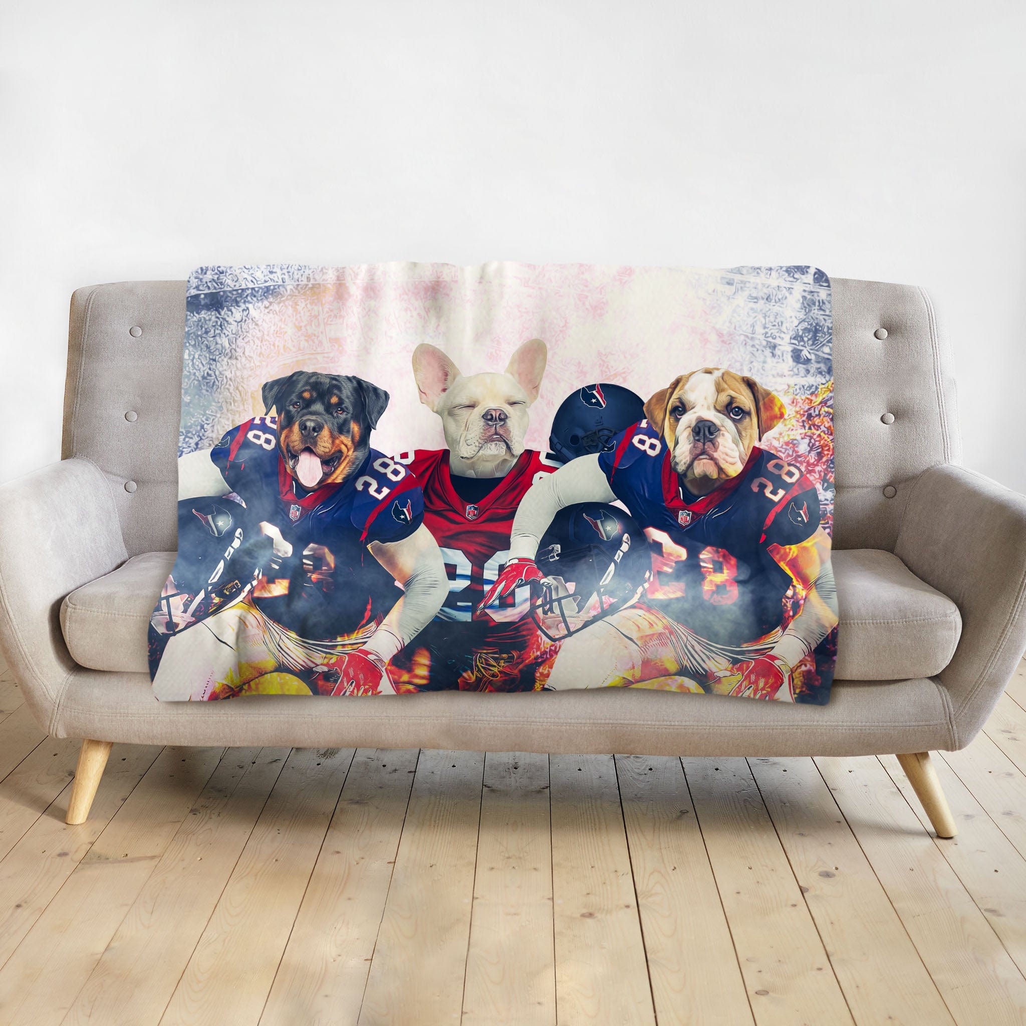 Personalized 3-pet blanket with dogs in Houston football uniforms, draped on a grey sofa.
