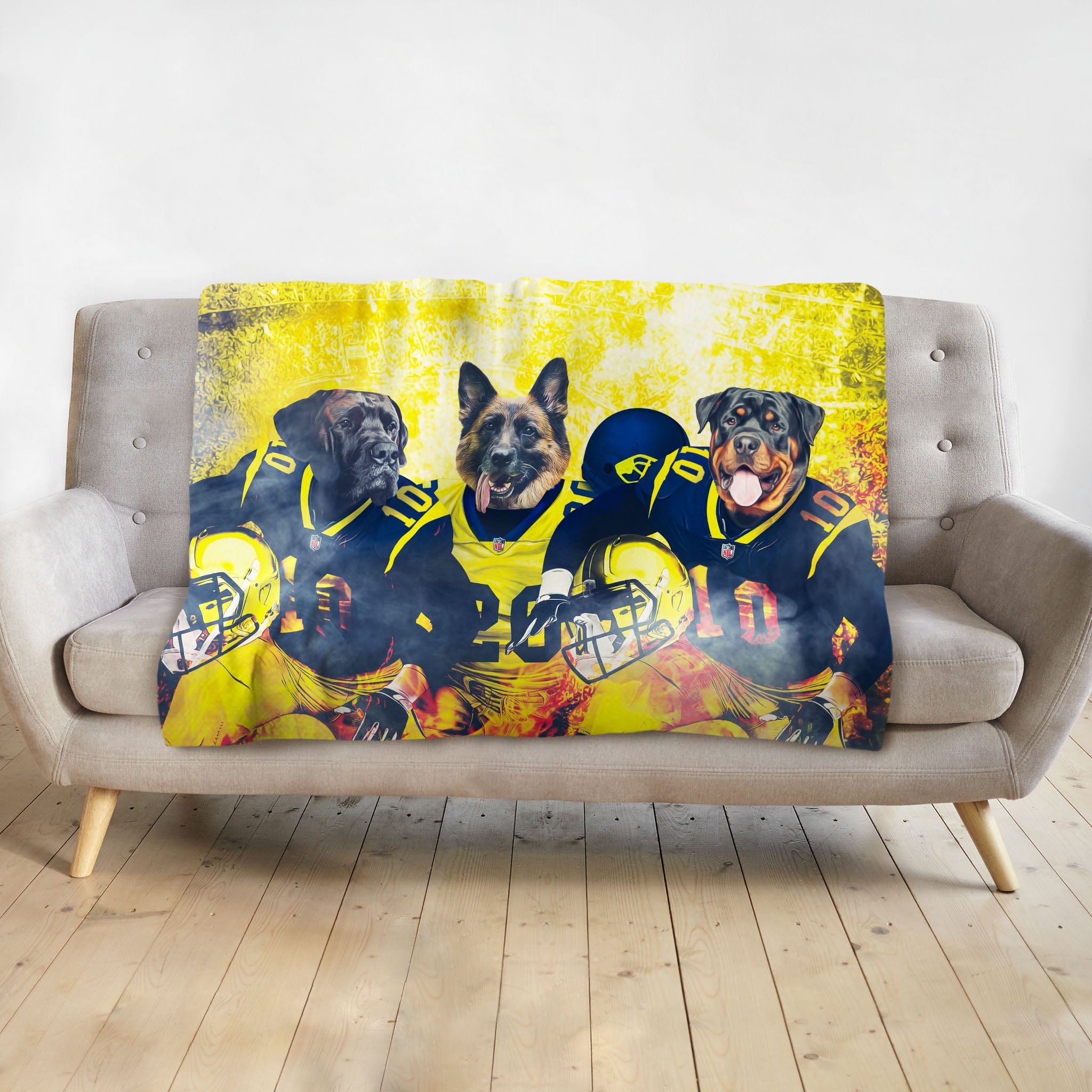 Personalized 3-pet blanket with dogs in football uniforms, yellow and blue, on a gray sofa.