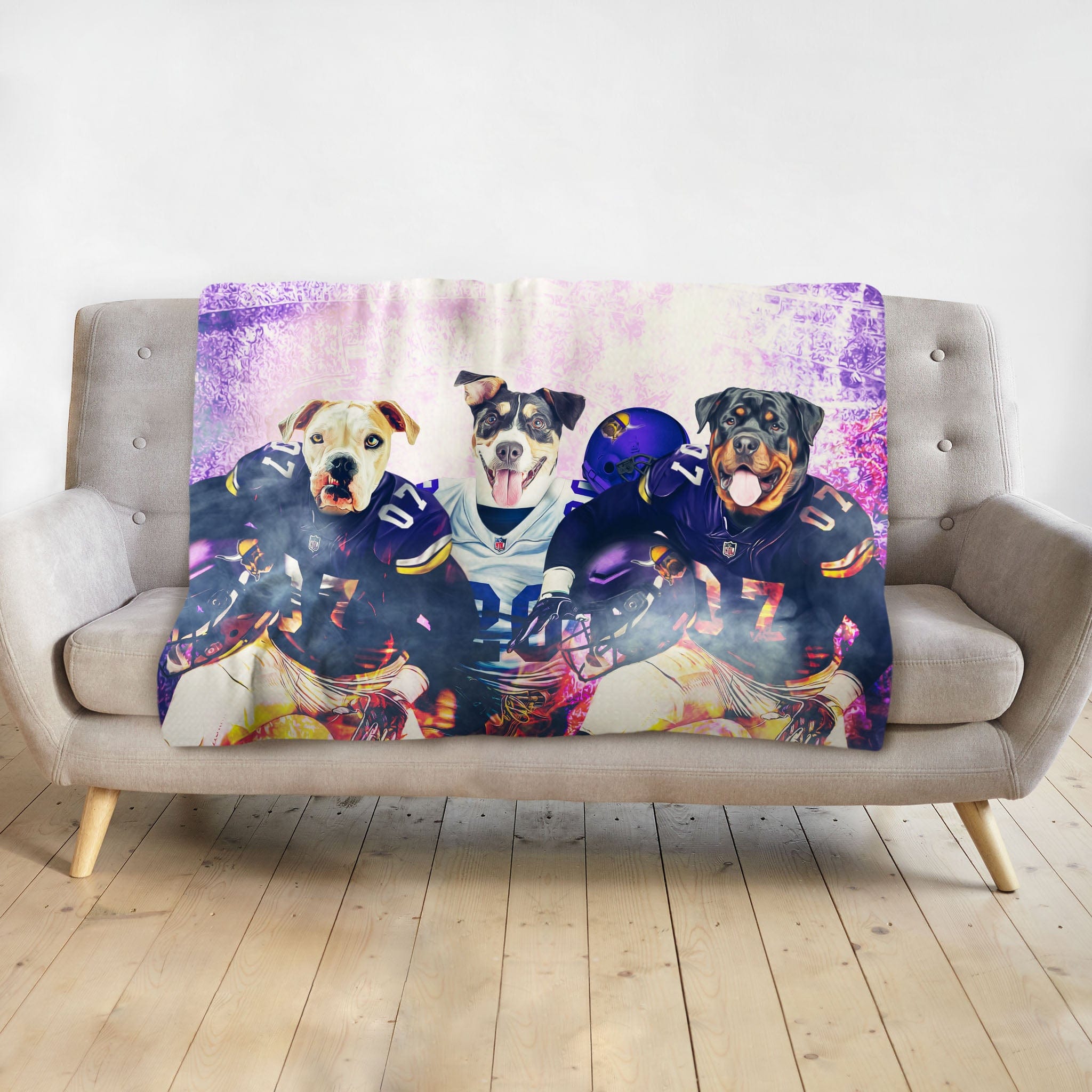 Personalized 3-pet blanket with dogs in football uniforms and helmets, on a gray couch.