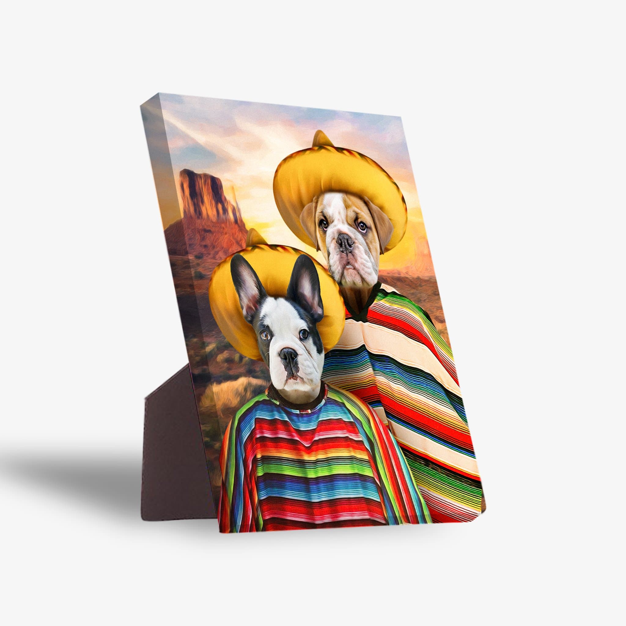 Two dogs in yellow sombreros and colorful striped ponchos on a personalized standing canvas with a desert background.