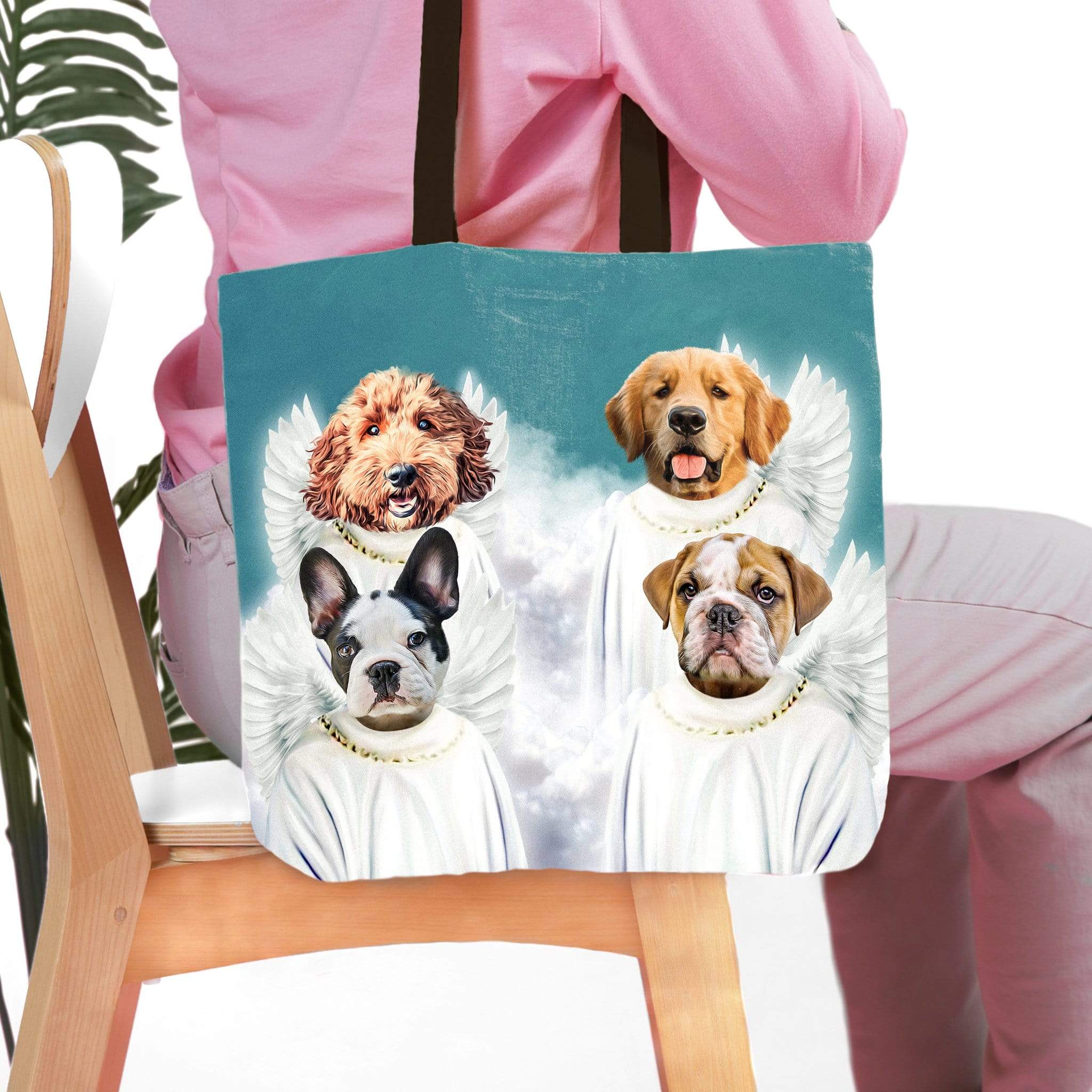 Personalized pet portrait tote bag featuring four dogs as angels on a blue background.