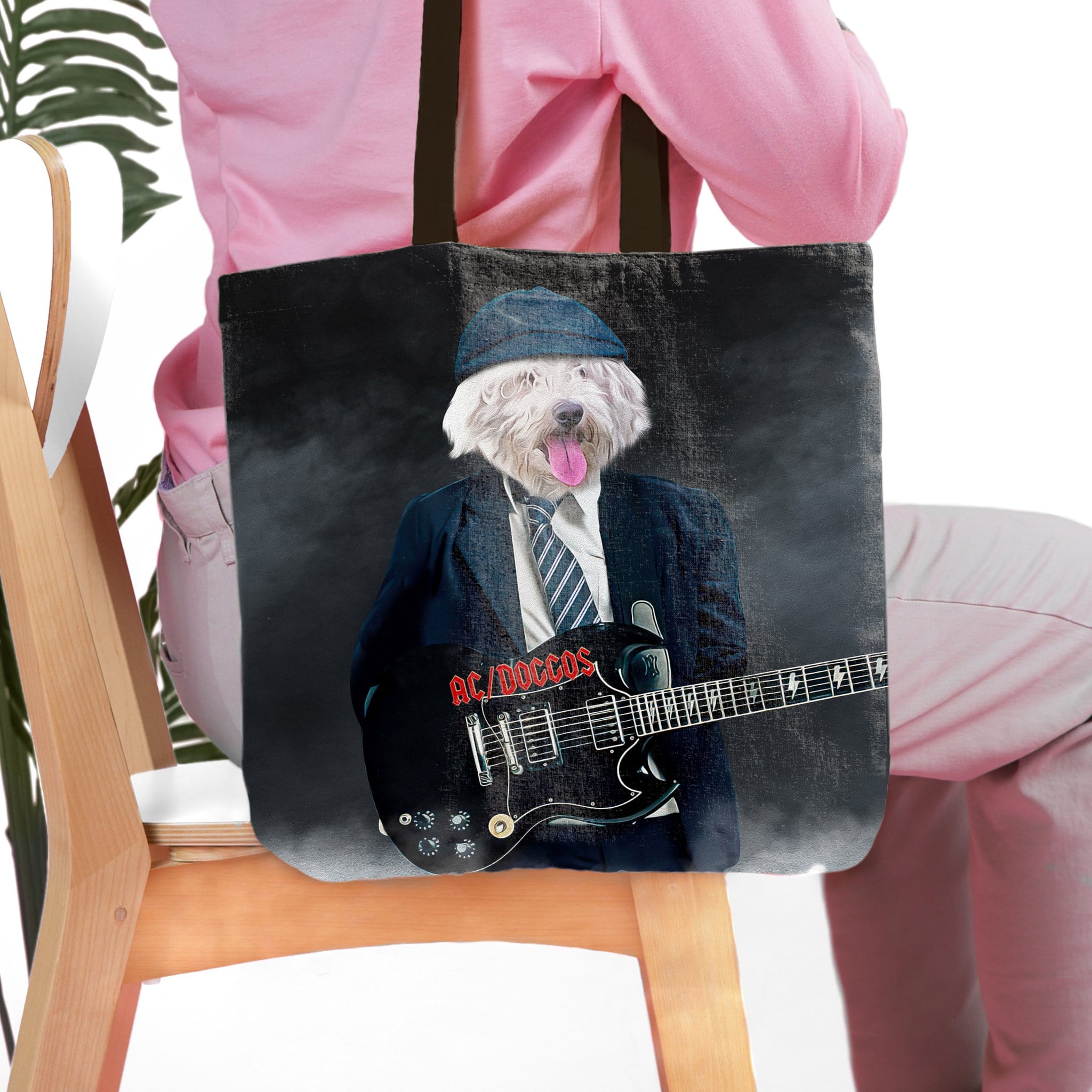 Personalized black tote bag with a custom pet portrait of a white dog dressed as a rock star playing guitar.