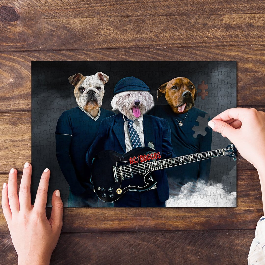 Personalized AC/Doggos 3-pet puzzle featuring dogs in rock band outfits, with hands assembling pieces.