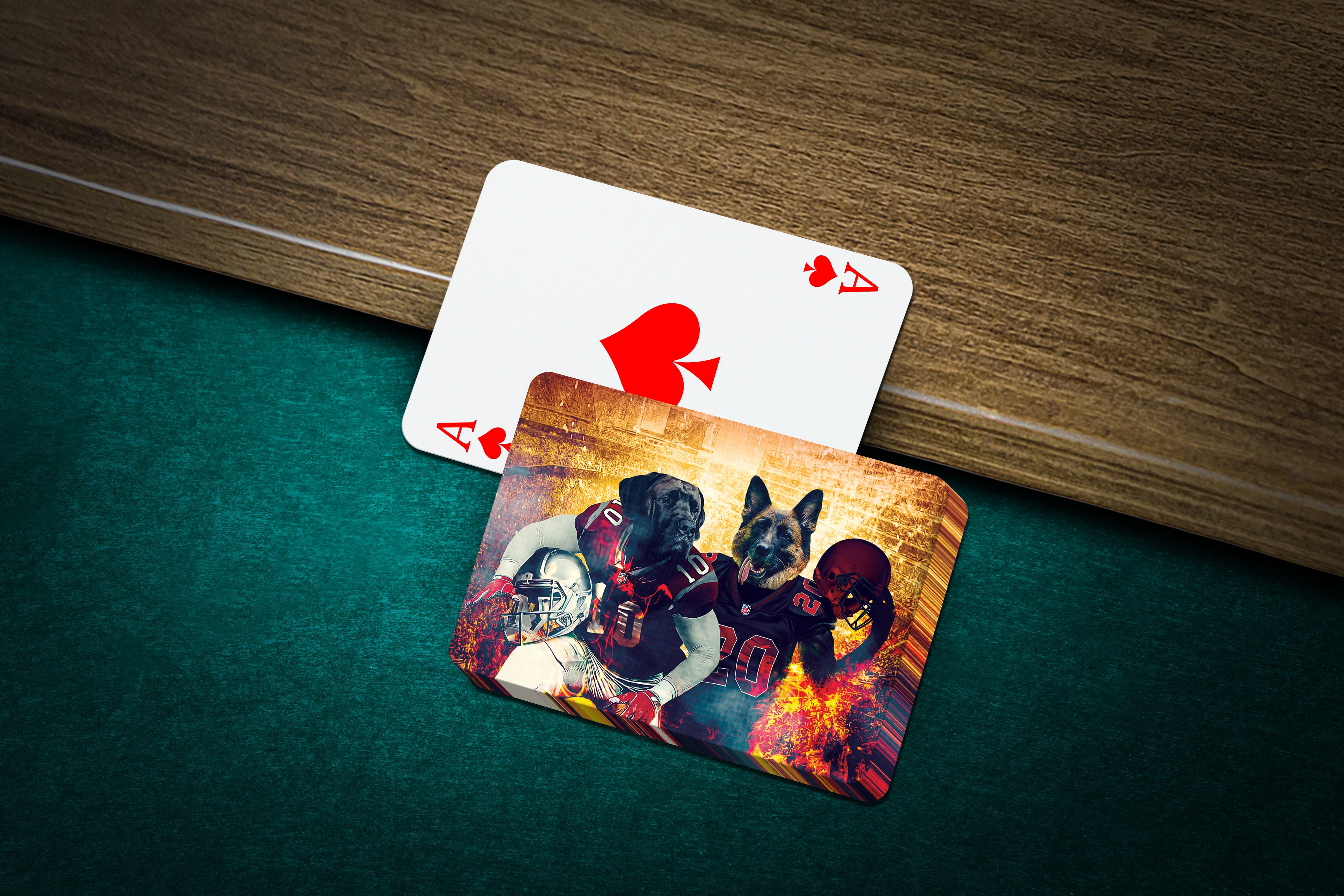 Personalized playing cards featuring two dogs in football uniforms on a green felt table.