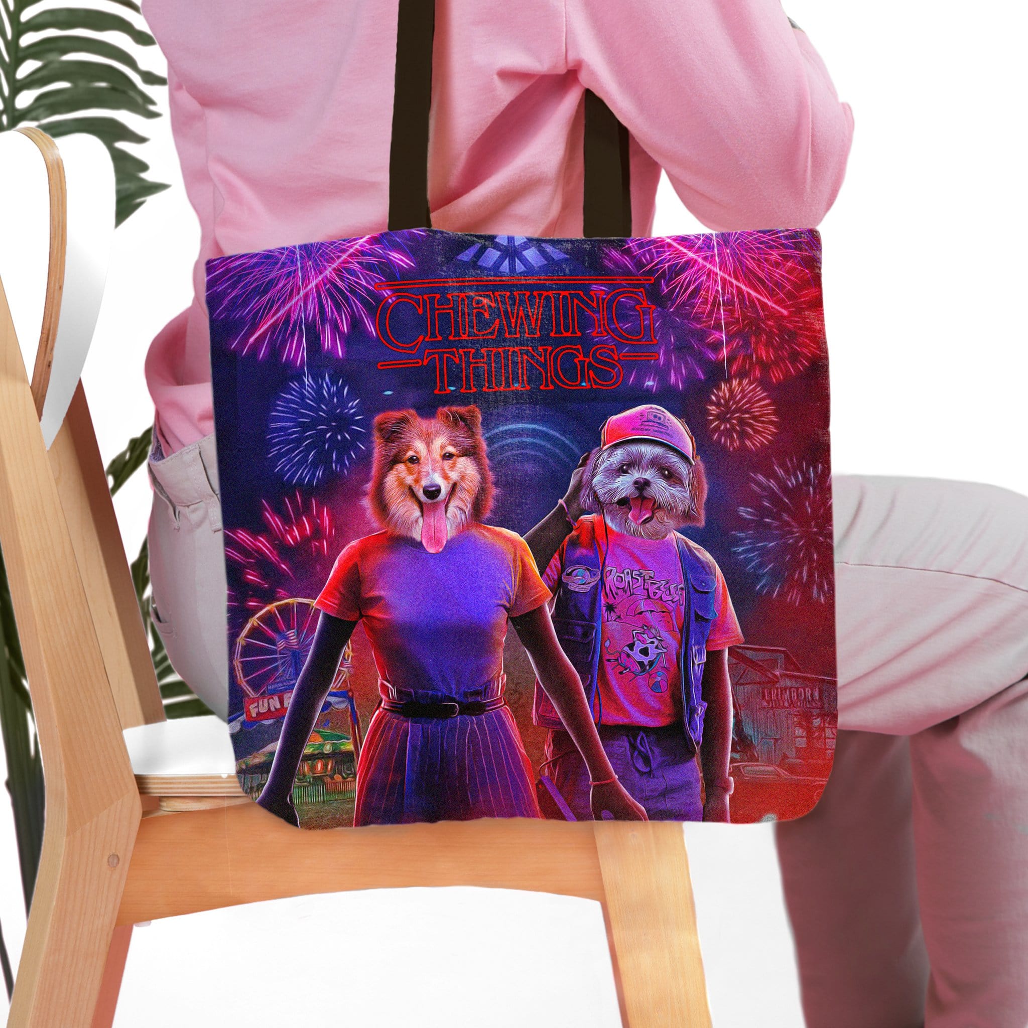 Personalized pet portrait tote bag featuring a dog and cat in a "Chewing Things" design with fireworks.