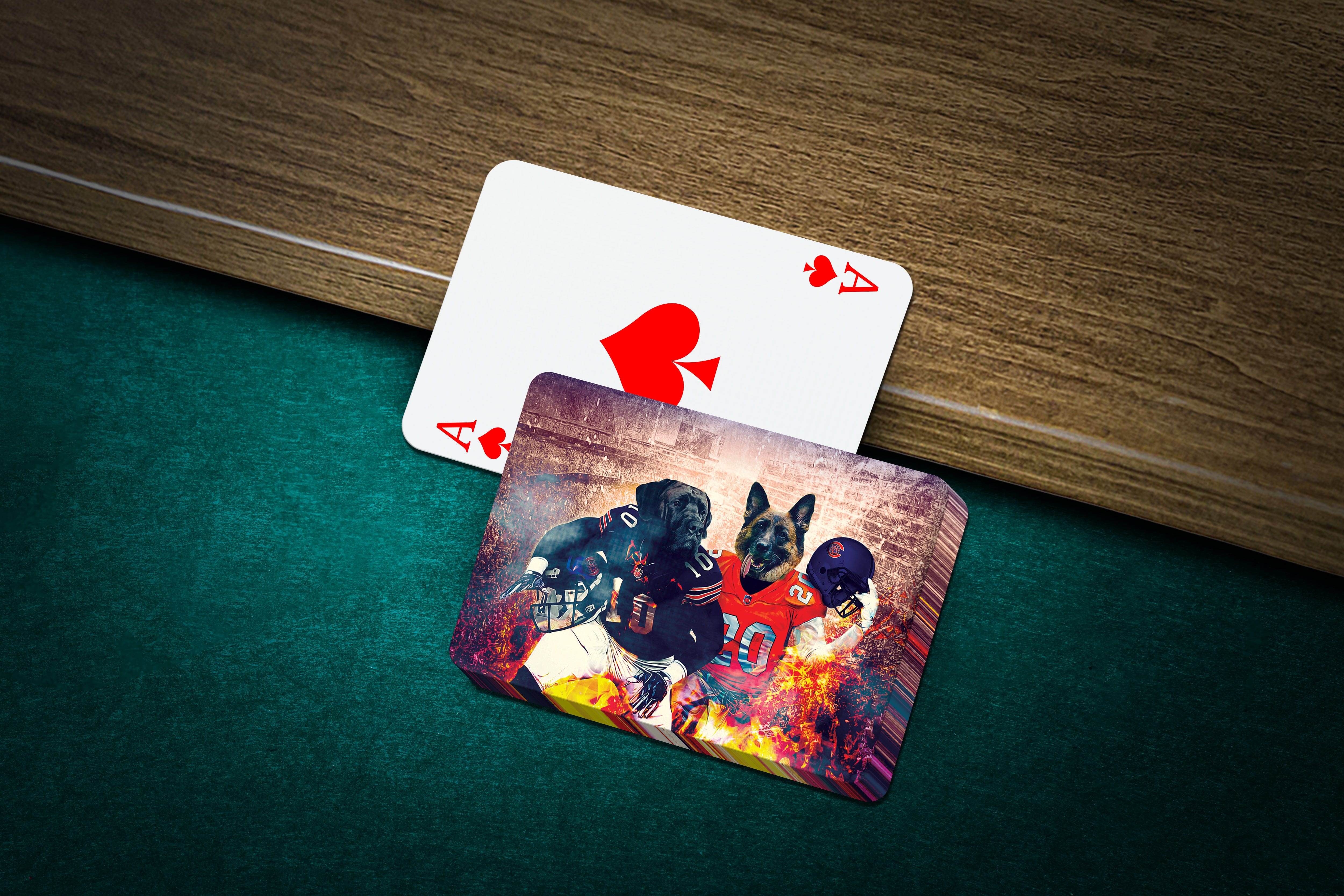 Personalized playing cards featuring two custom dog portraits in football uniforms on a green felt table.
