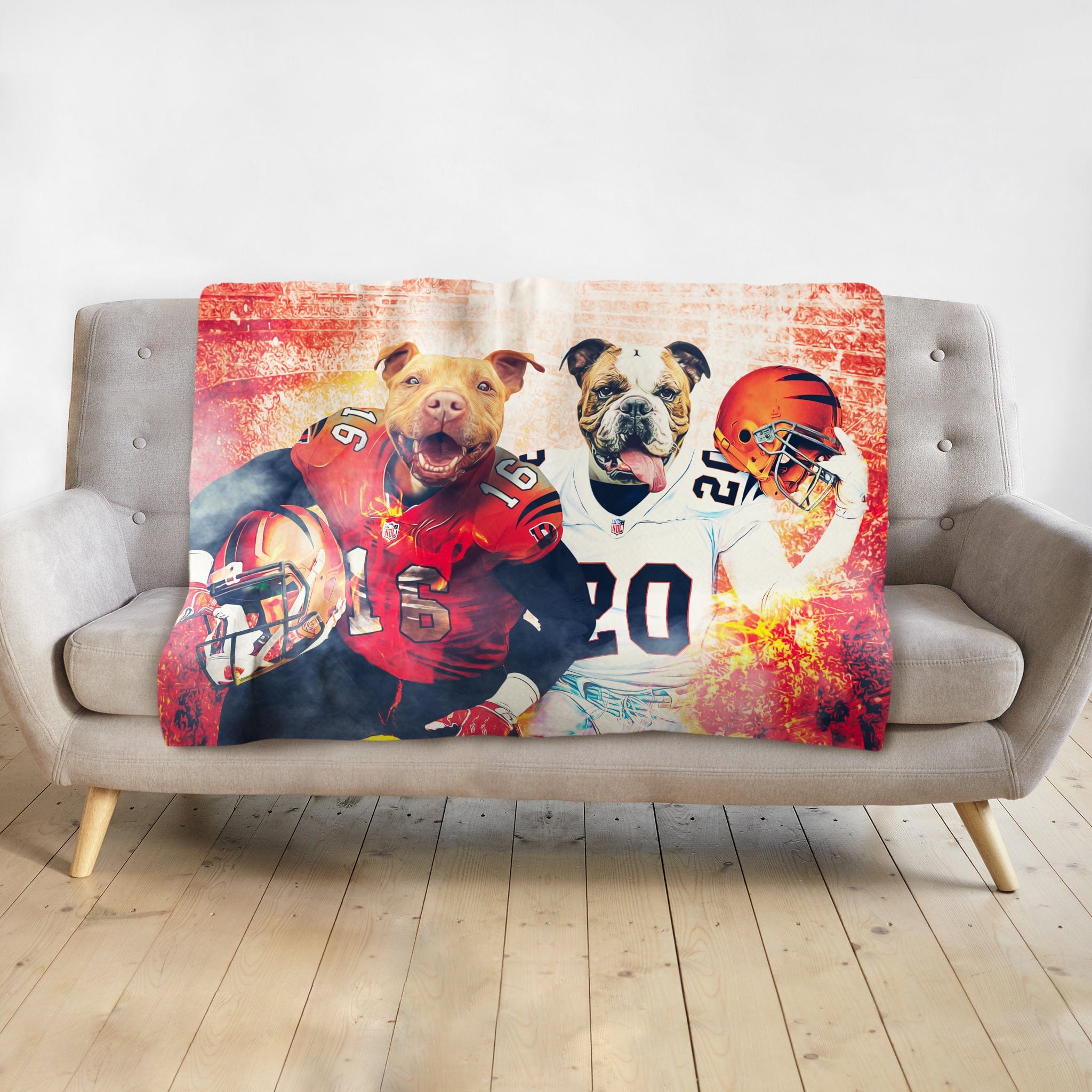 Personalized football pet blanket featuring two dogs in team jerseys on a gray sofa.