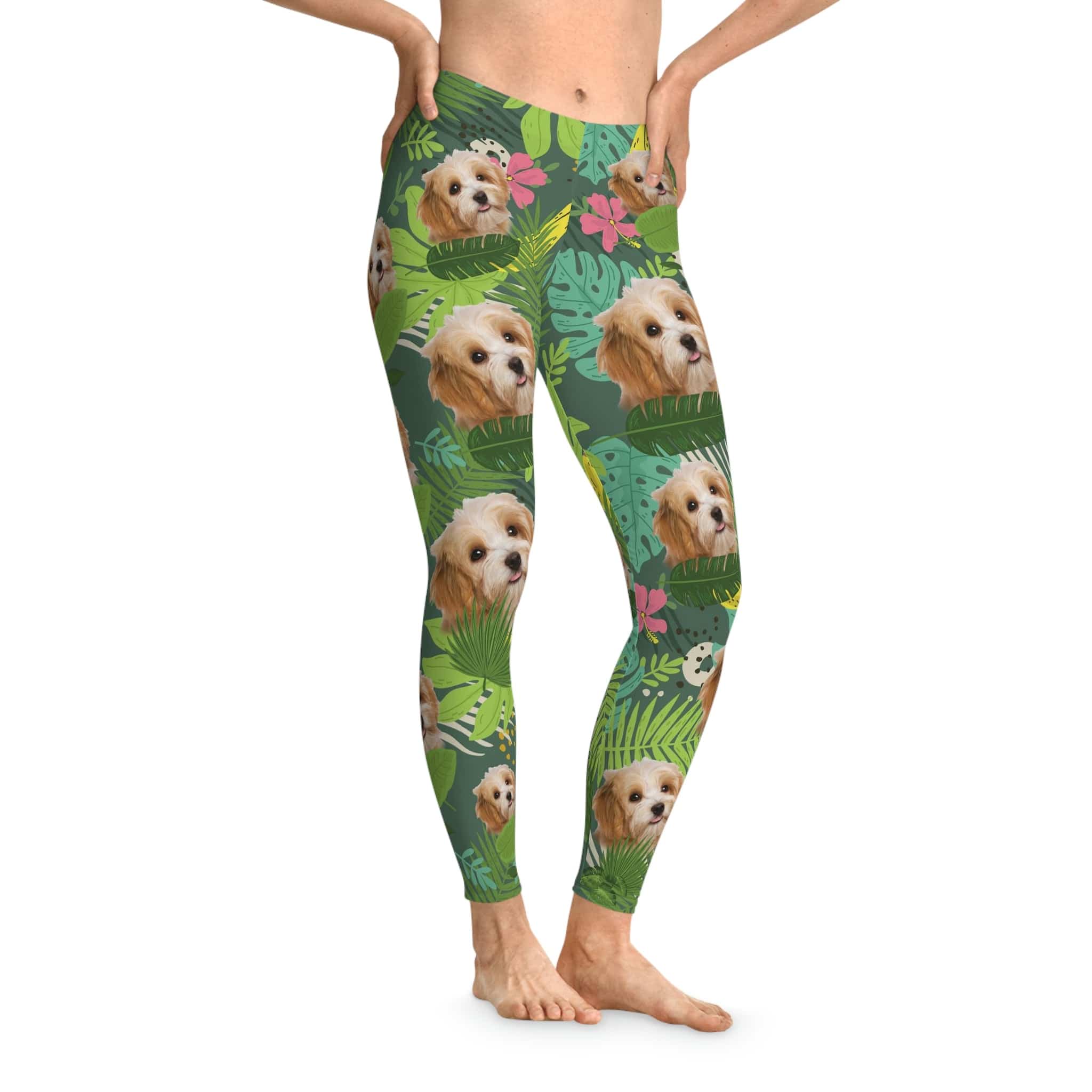 Custom leafy green leggings with a tropical print and multiple Cavalier King Charles Spaniel faces.