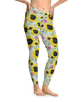 Custom leggings with a "Sunflower Sky" design featuring black pugs in sunflowers and pink flowers.