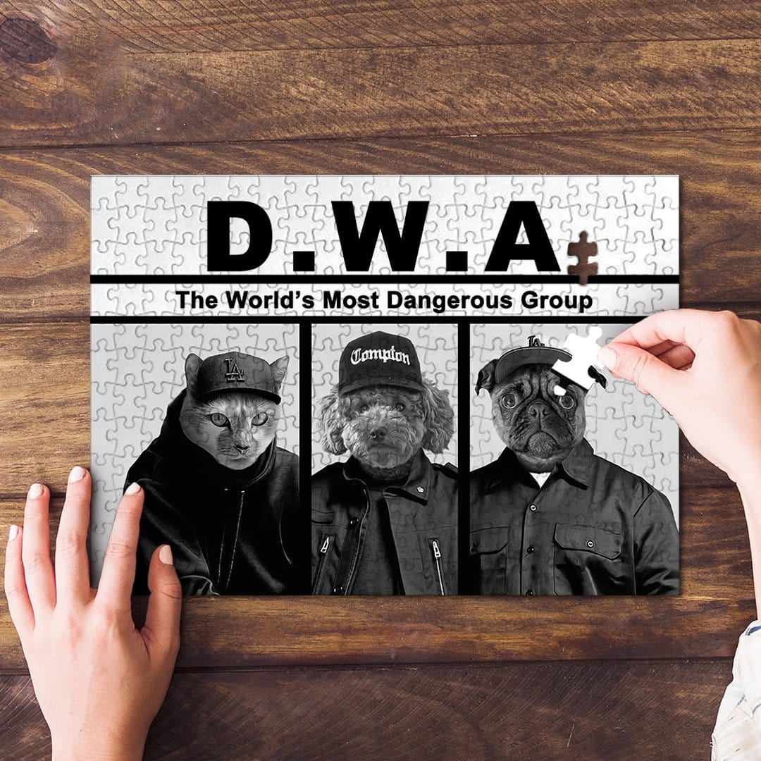 Personalized D.W.A. pet puzzle featuring a cat, poodle, and pug in black and white, with a hand placing a piece.