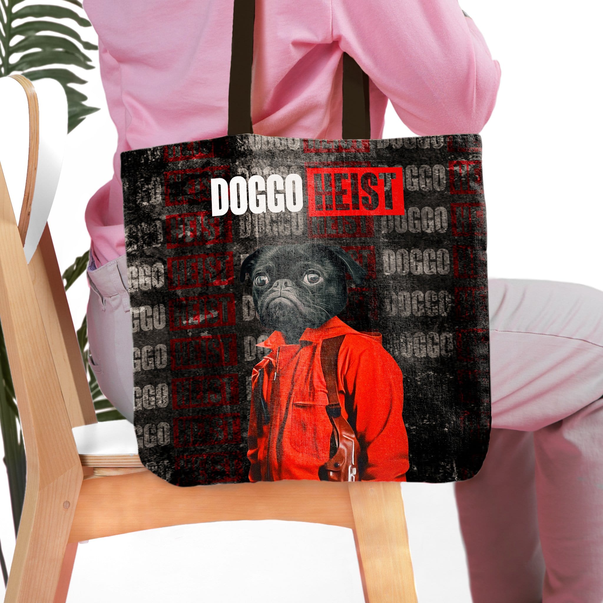 Personalized black tote bag with a custom pug pet portrait in a red heist costume.