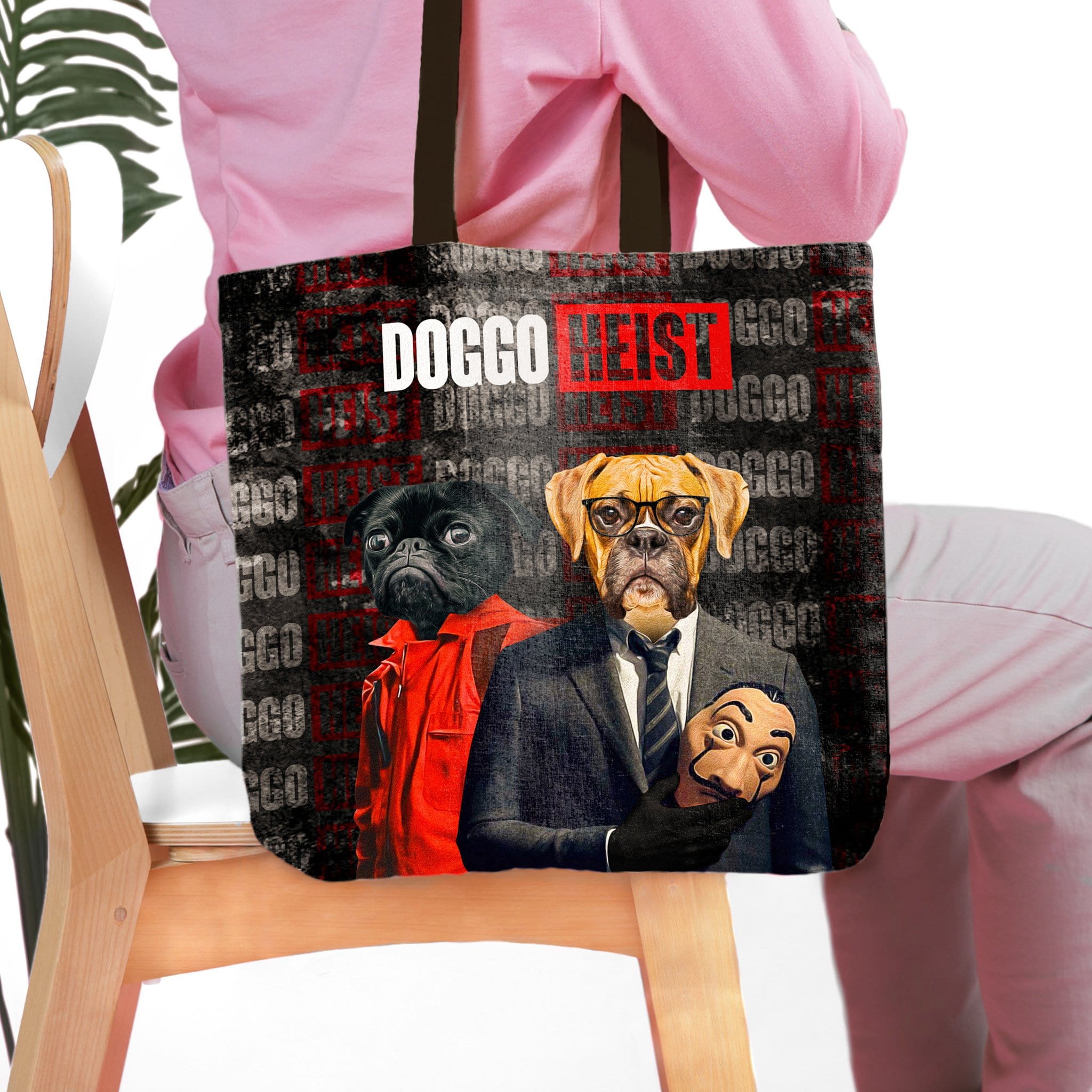 Personalized black tote bag with two custom pet portraits in a "Doggo Heist" style.