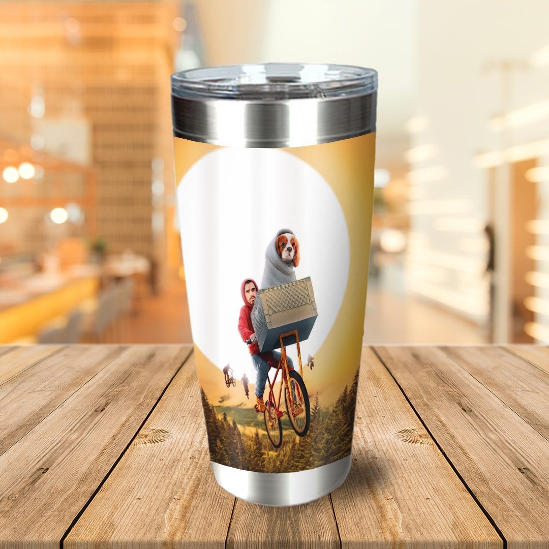 Personalized stainless steel tumbler with a custom dog and human riding a bicycle against a sunset.