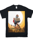 Black Gildan t-shirt with a personalized design of a dog in a blanket on a bike, flying against a full moon.