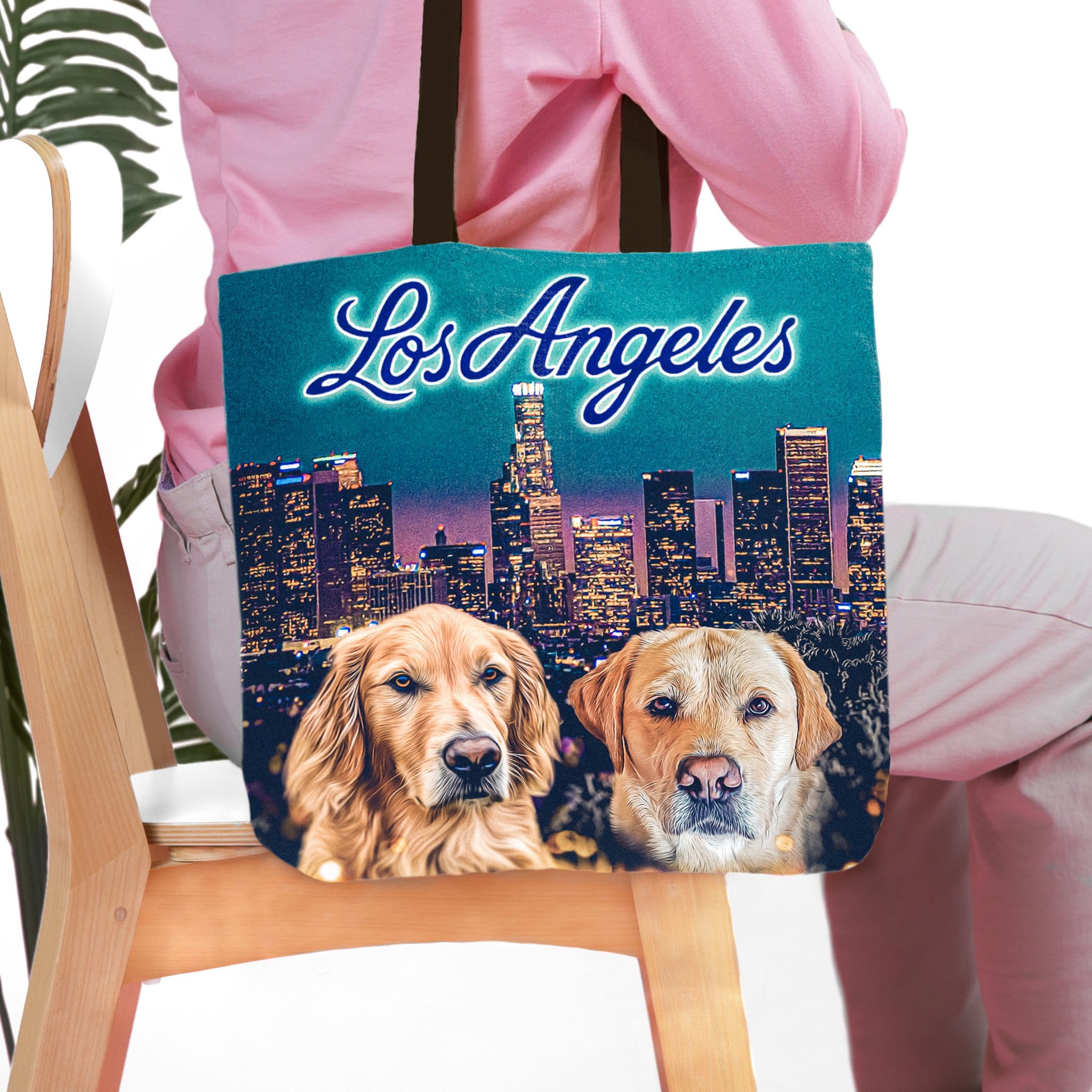 Personalized 'Doggos of Los Angeles' tote bag with two custom dog portraits and city skyline.