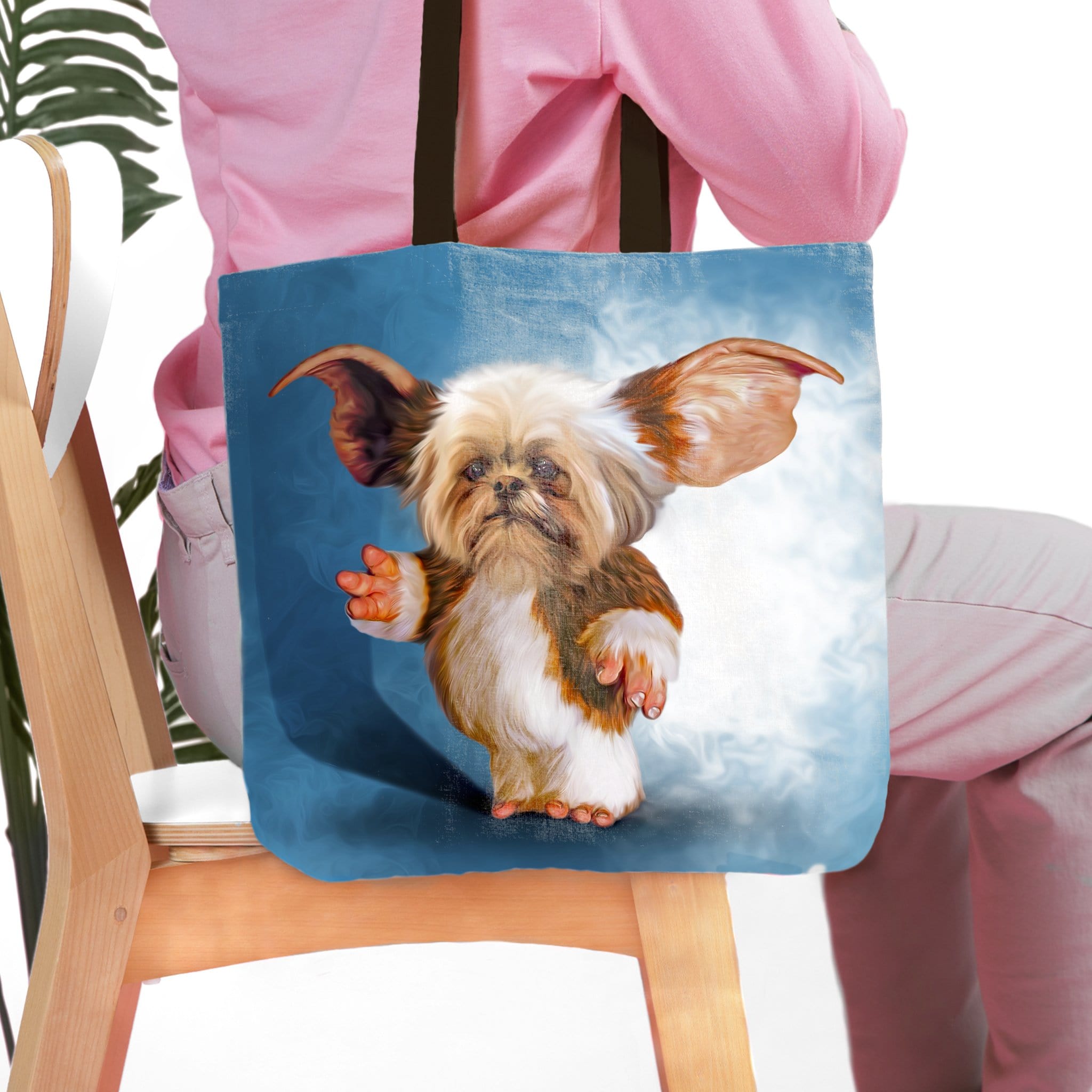 Personalized tote bag with a custom Gizmo-style dog portrait on a blue background.