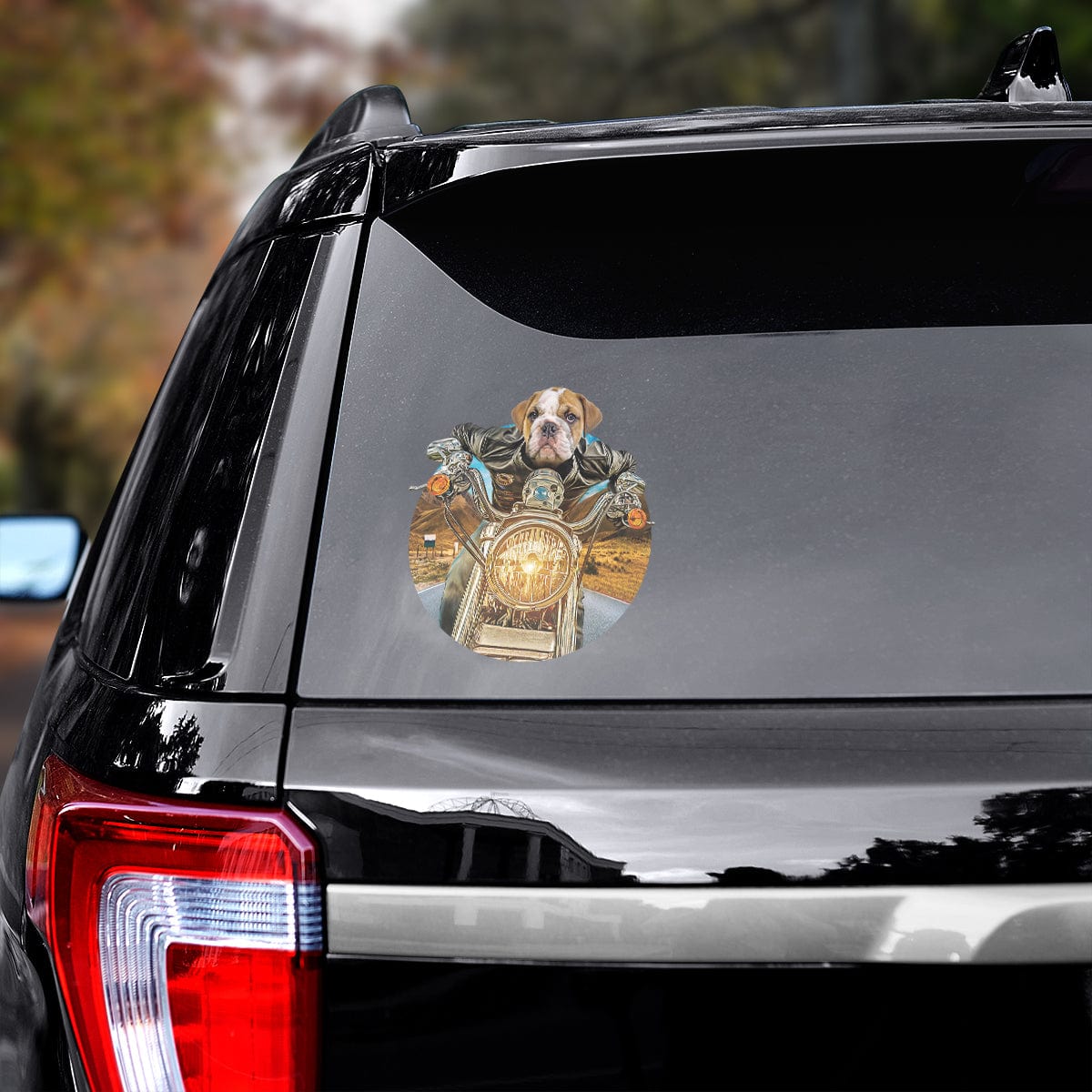 Custom bulldog pet decal on a black car window, featuring a dog in a leather jacket riding a motorcycle.
