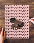 Personalized 'Ho Ho Doggo' pet puzzle featuring a pug as a chocolate Swiss roll on a pink background.