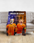 Custom personalized blanket with two dogs in orange soccer uniforms, "Noah & Liam" text.
