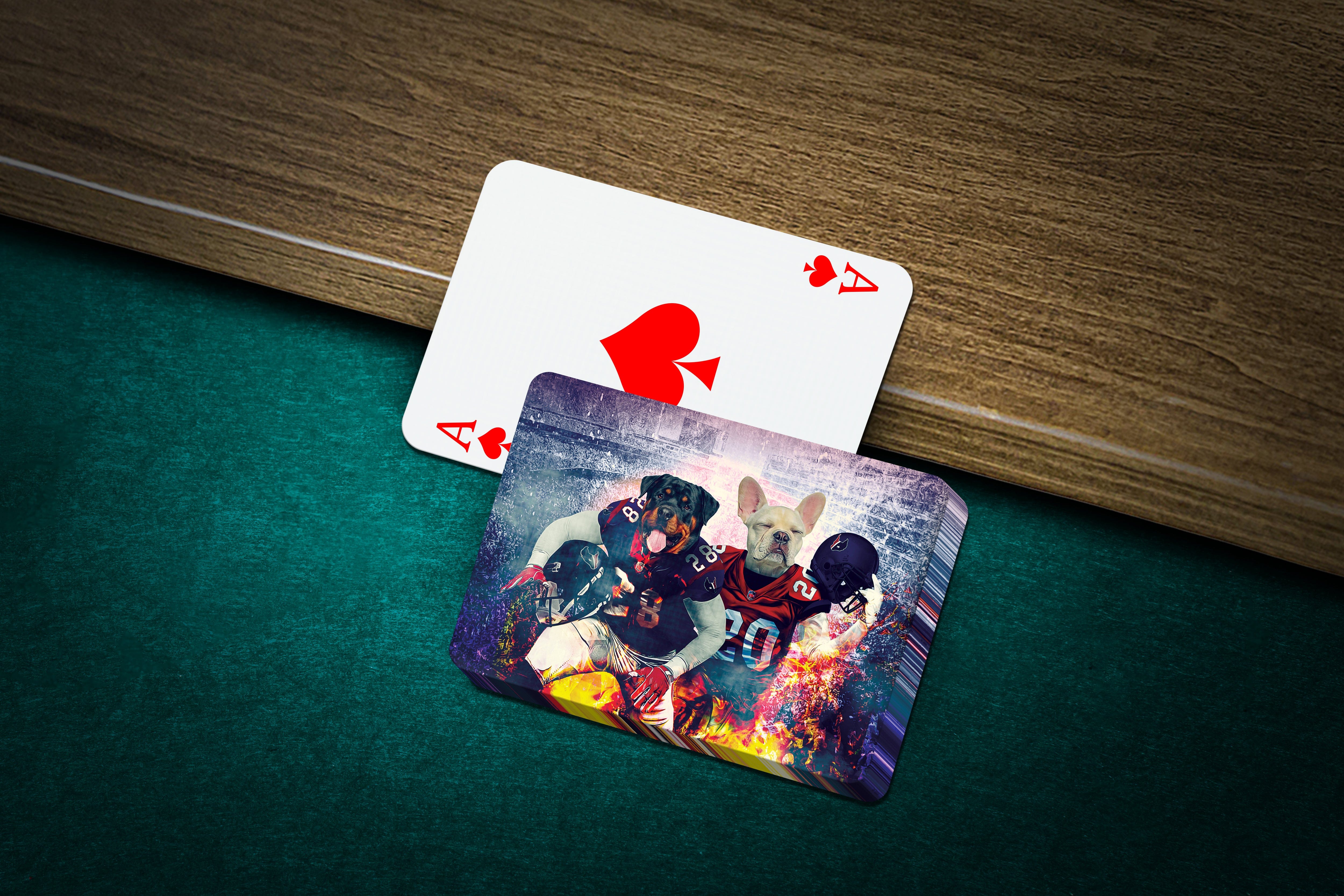 Personalized playing cards featuring custom dog portraits in football uniforms, on a green felt table.