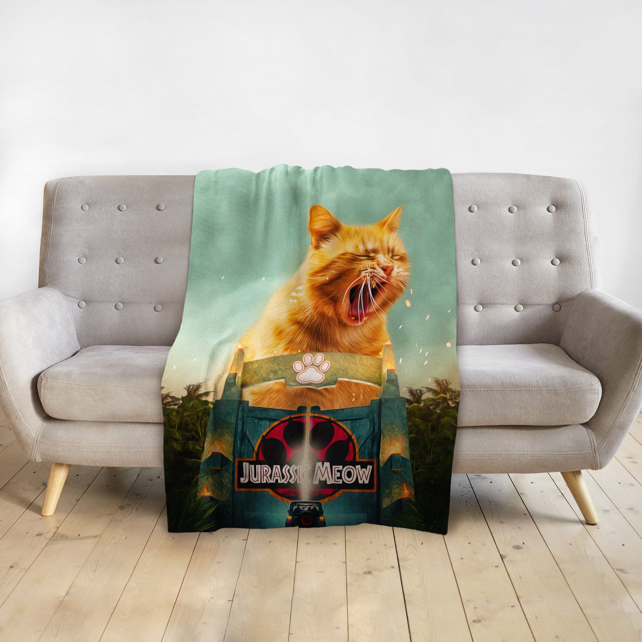 Personalized pet blanket with a custom Jurassic Meow portrait of an orange cat yawning.
