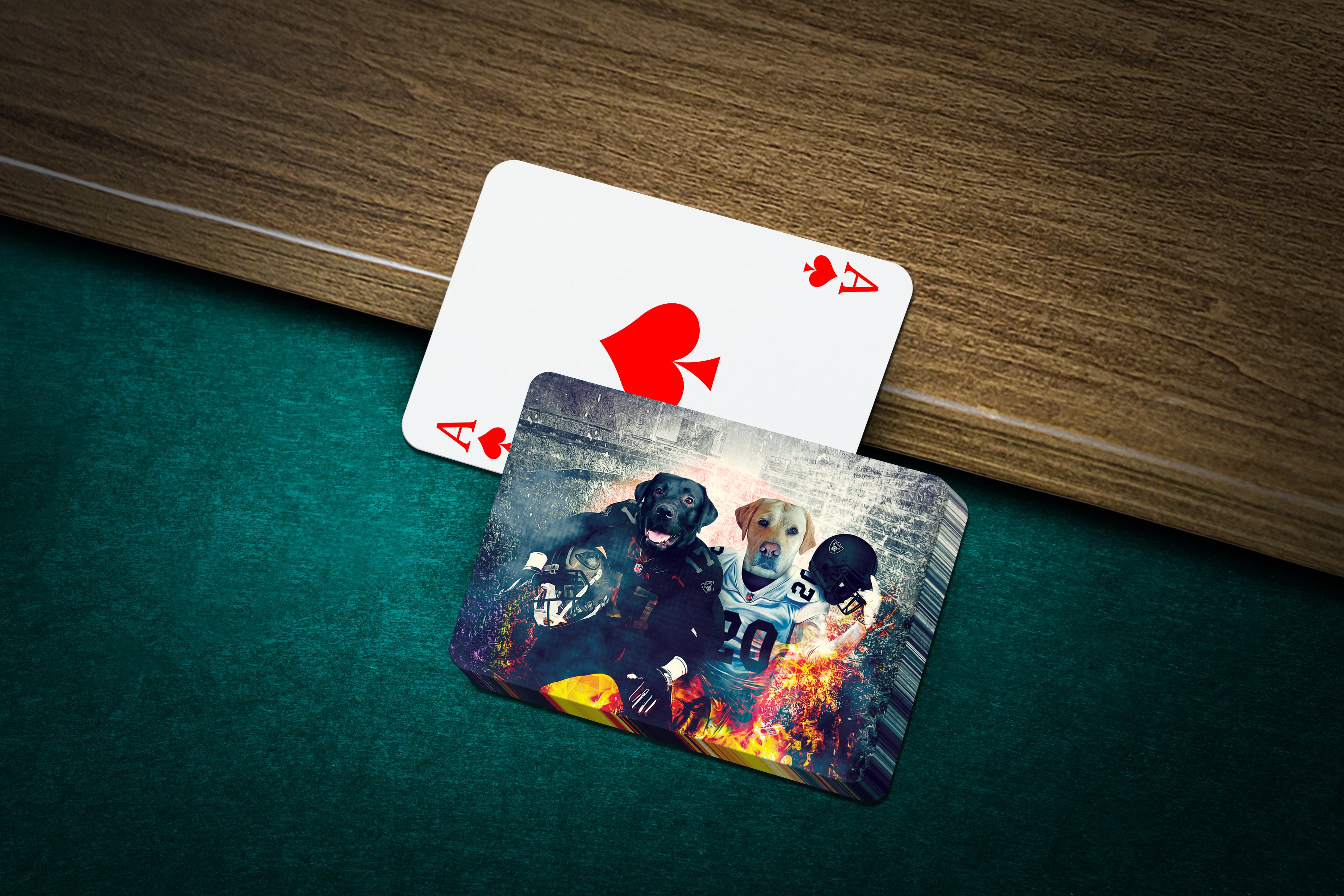 Personalized playing cards featuring two dogs in football uniforms on a green felt table.