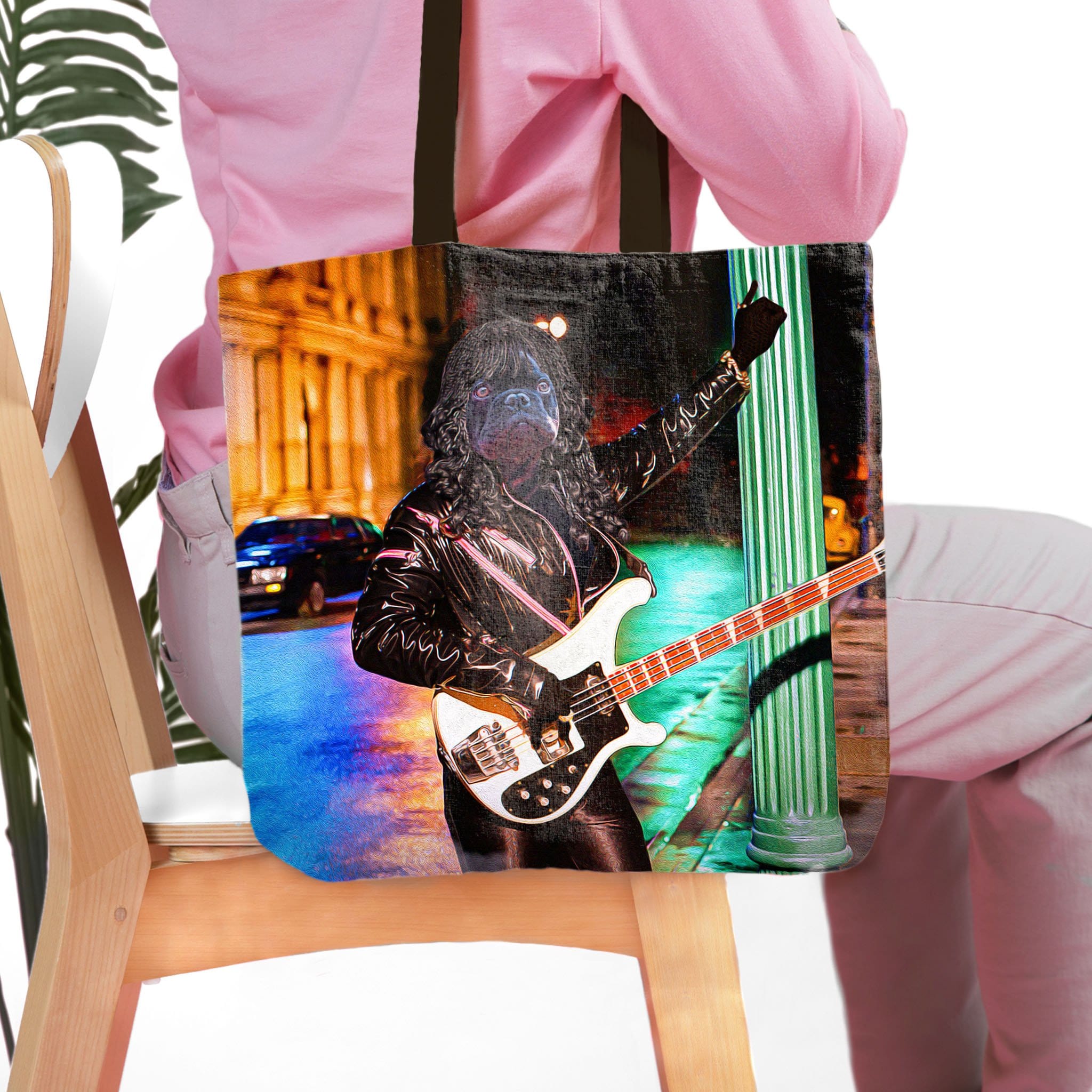 Personalized black tote bag with a custom pet portrait of a dog as a rock star playing a bass guitar.