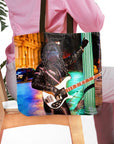 Personalized black tote bag with a custom pet portrait of a dog as a rock star playing a bass guitar.
