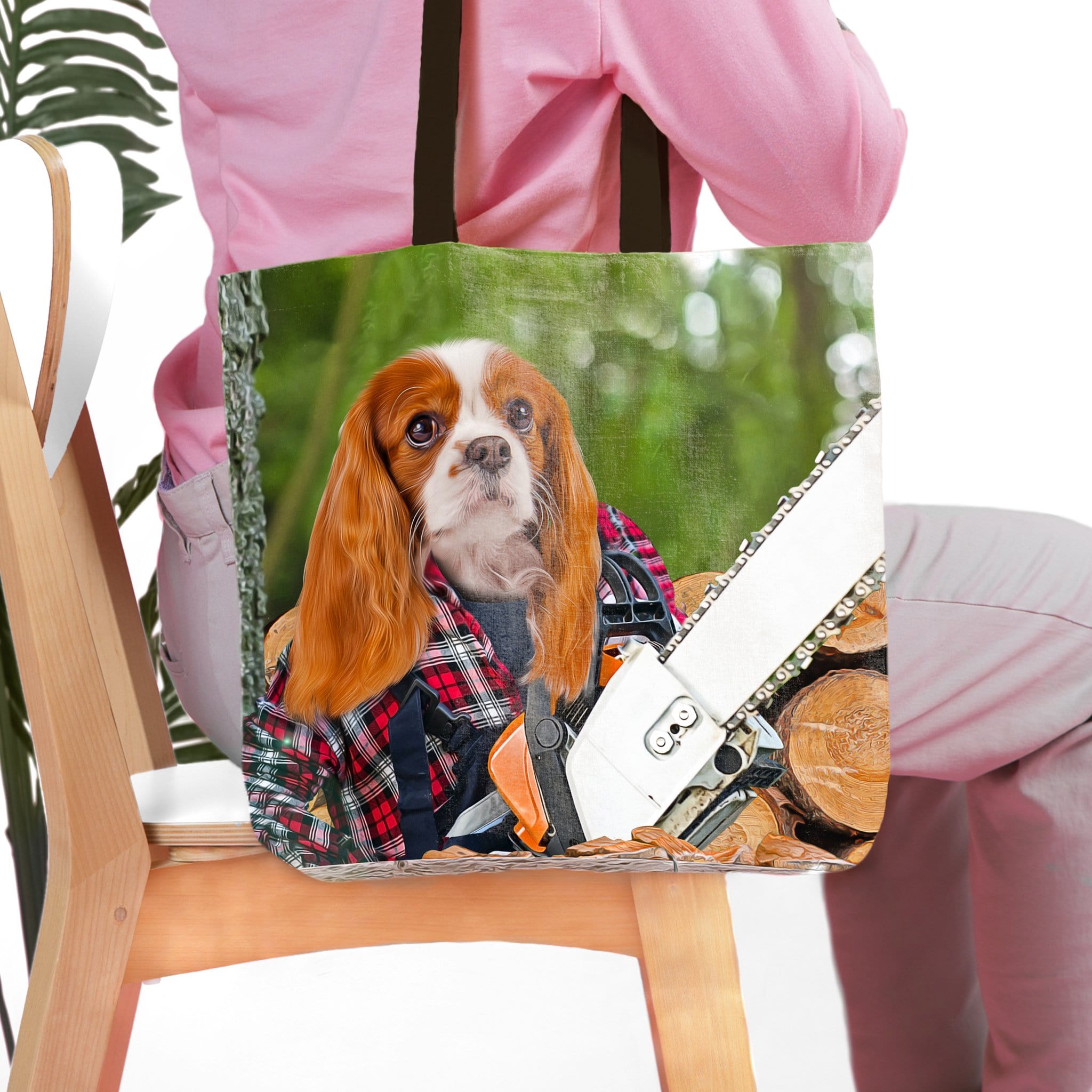 Personalized tote bag with a Cavalier King Charles Spaniel pet portrait as a lumberwoman with a chainsaw.