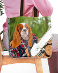Personalized tote bag with a Cavalier King Charles Spaniel pet portrait as a lumberwoman with a chainsaw.