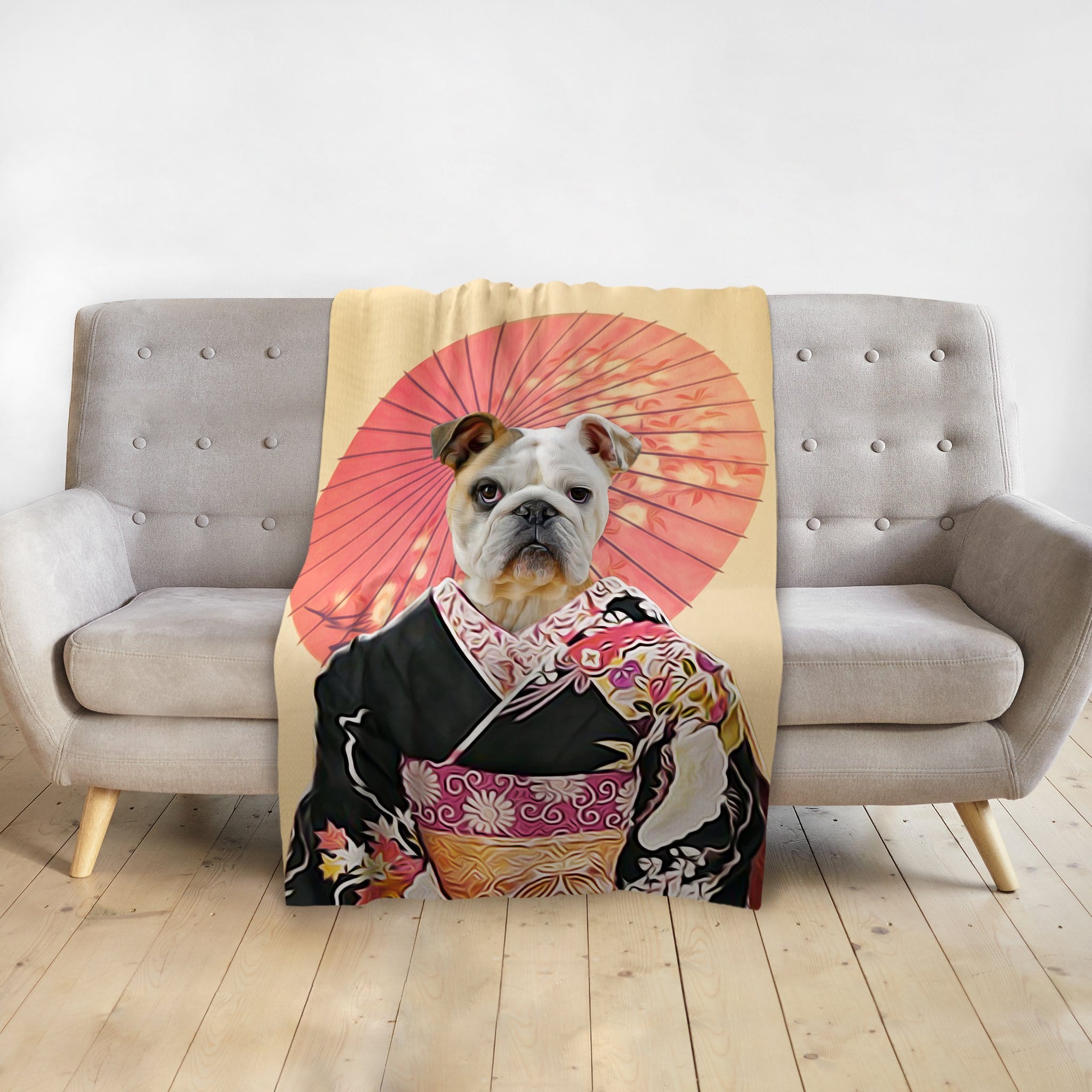 Personalized pet blanket featuring a bulldog in a black kimono with a red umbrella, draped over a gray sofa.