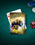 Personalized playing cards featuring a dog in a Michigan Wolverines football uniform, "BURKEE" text, on a green felt table.