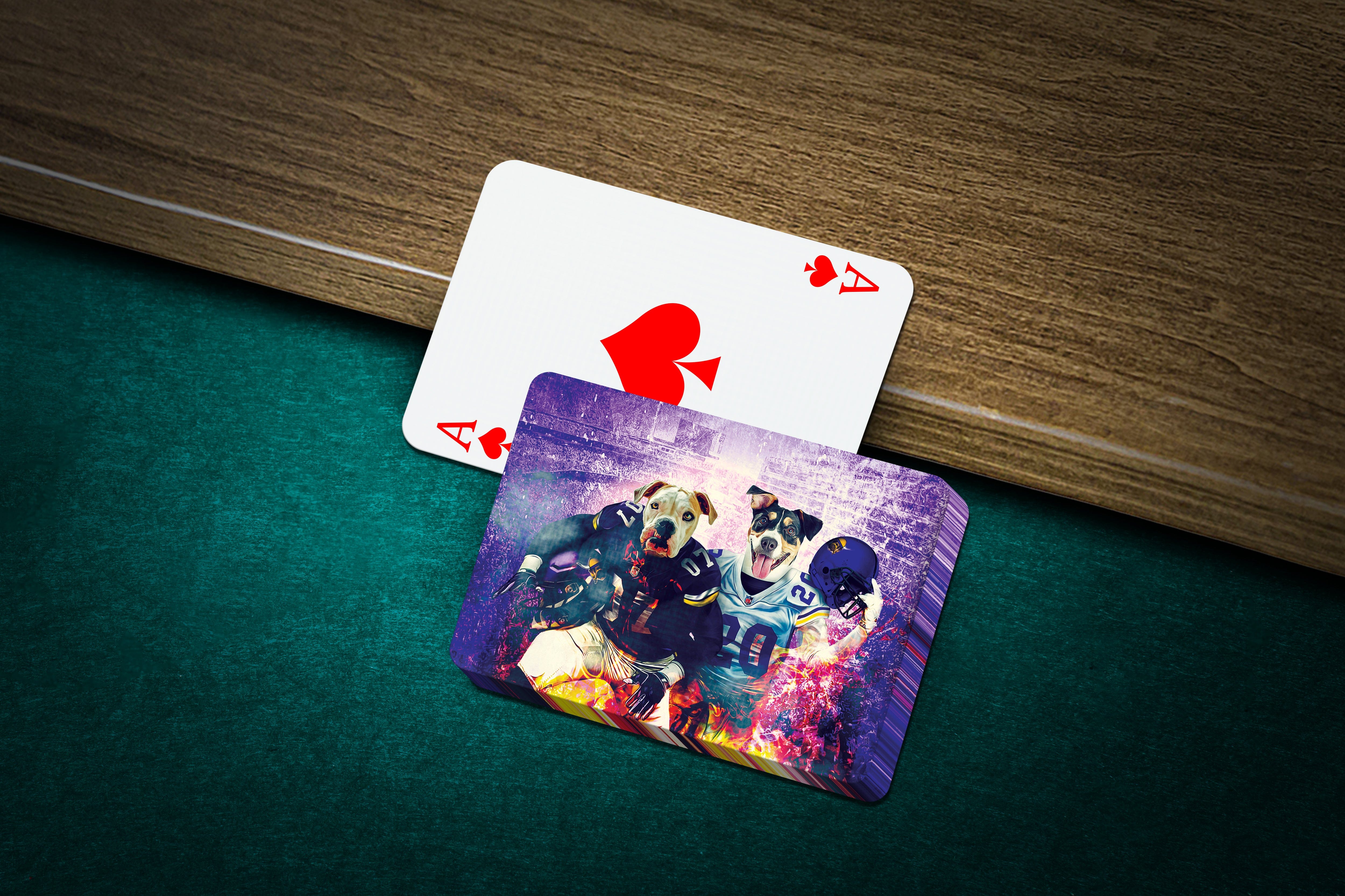 Custom personalized playing cards featuring two dogs in football uniforms, on a green felt table.