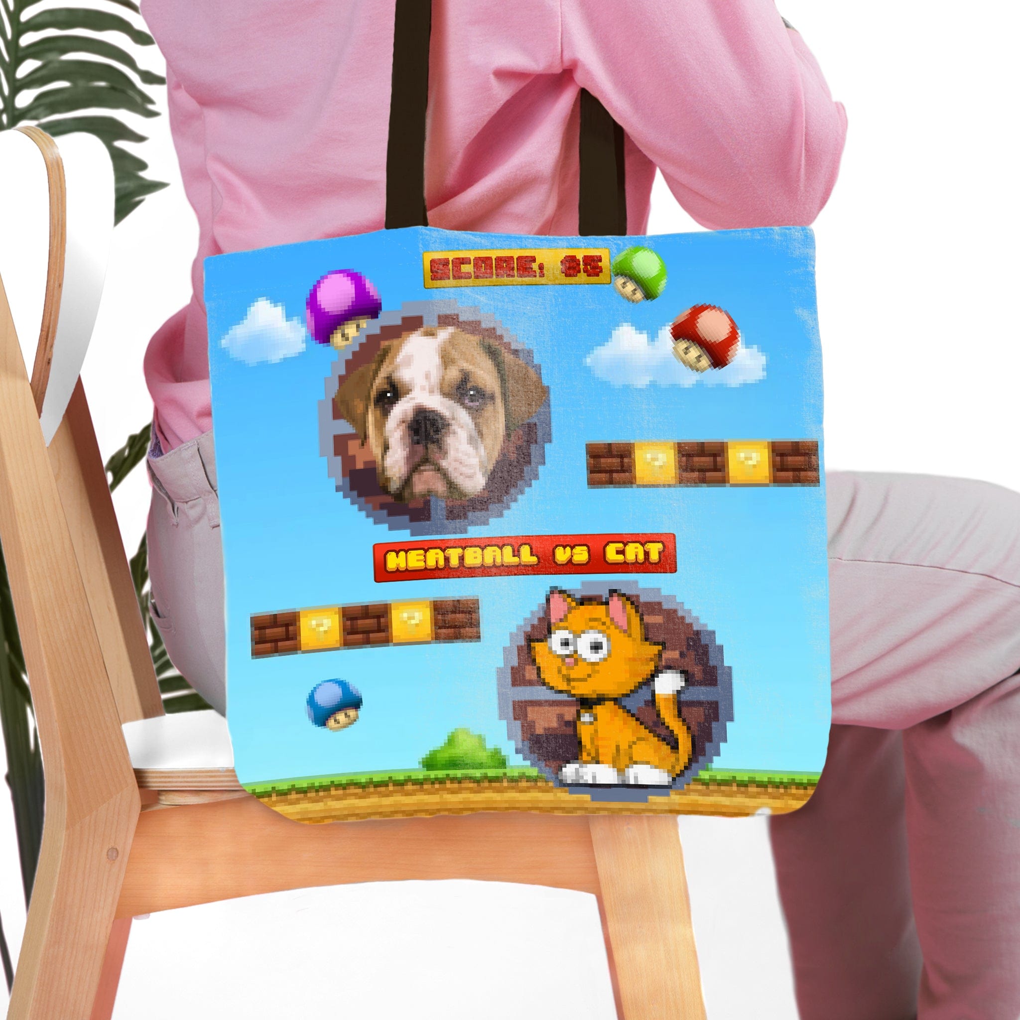 Personalized pet portrait tote bag featuring a bulldog and cat in a retro video game pixel art style.